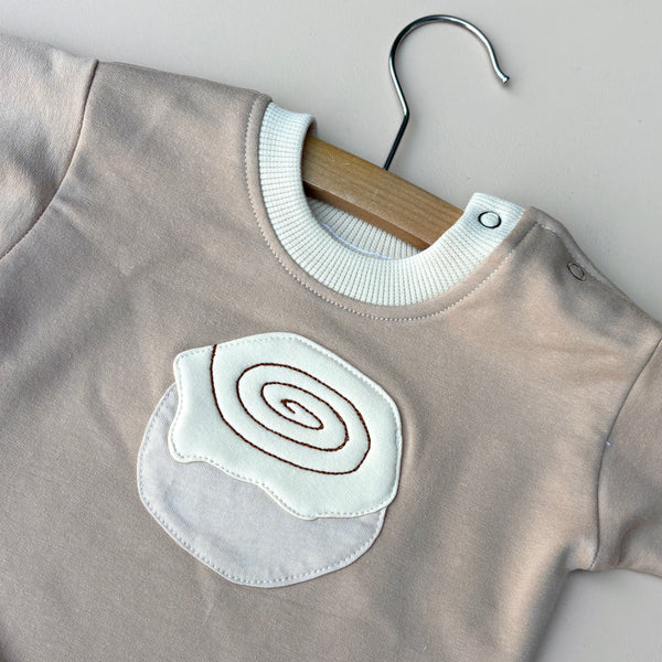 Cinnamon scroll sweater onesie
